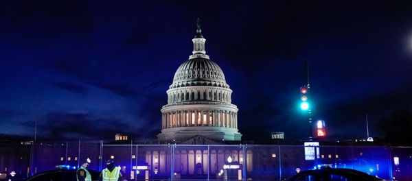 The U.S. Capitol is seen behind heavy-duty security fencing the day after supporters of US President Donald Trump stormed the Capitol in Washington, DC, 7 January 2021. The U.S. Capitol is seen behind heavy-duty security fencing the day after supporters of US President Donald Trump stormed the Capitol in Washington, DC, 7 January 2021. - Sputnik International