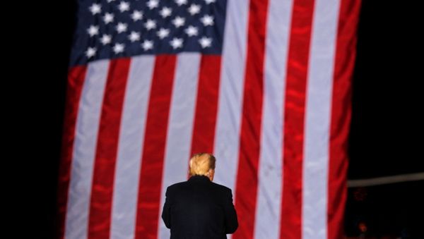US President Donald Trump stands in front of the stars and stripes while campaigning for Republican Senator Kelly Loeffler on the eve of the run-off election to decide both of Georgia's Senate seats, in Dalton, Georgia, US, 4 January 2021. - Sputnik International