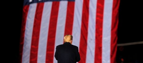 US President Donald Trump stands in front of the stars and stripes while campaigning for Republican Senator Kelly Loeffler on the eve of the run-off election to decide both of Georgia's Senate seats, in Dalton, Georgia, US, 4 January 2021. - Sputnik International
