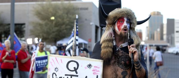 A Qanon believer speaks to a crowd of President Donald Trump supporters outside of the Maricopa County Recorder's Office where votes in the general election are being counted, in Phoenix, Thursday, Nov. 5, 2020. A Qanon believer speaks to a crowd of President Donald Trump supporters outside of the Maricopa County Recorder's Office where votes in the general election are being counted, in Phoenix, Thursday, Nov. 5, 2020. - Sputnik International