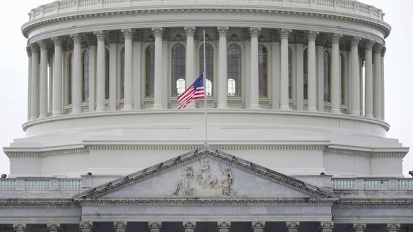 An American flag flies at half-staff in remembrance of U.S. Capitol Police Officer Brian Sicknick above the Capitol Building in Washington, Friday, Jan. 8, 2021 - Sputnik International