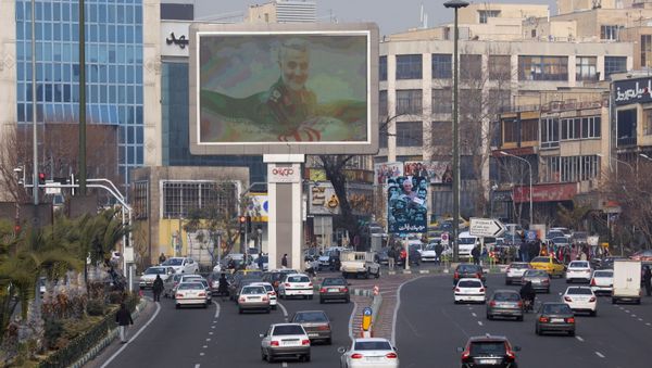 A photo of senior Iranian military commander General Qassem Soleimani, is seen on a city giant screen on a street during the one year anniversary of his killing in a U.S. attack, in Tehran, Iran January 1, 2021. - Sputnik International