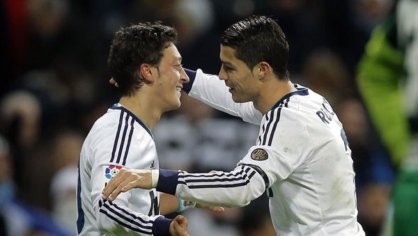 Real Madrid's Mesut Ozil from Germany, left, celebrates with Cristiano Ronaldo from Portugal after scoring a goal against Atletico de Madrid during a Spanish La Liga football match at the Santiago Bernabeu stadium in Madrid, Saturday, 1 December 2012. Real Madrid's Mesut Ozil from Germany, left, celebrates with Cristiano Ronaldo from Portugal after scoring a goal against Atletico de Madrid during a Spanish La Liga football match at the Santiago Bernabeu stadium in Madrid, Saturday, 1 December 2012. - Sputnik International