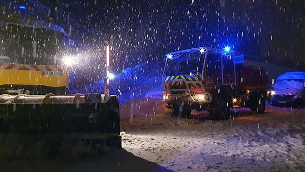 This handout picture released by the Haute-Savoie Prefecture on January 13, 2021, shows French Red Cross rescuers intervening on the A40 highway near Bellegarde-sur-Valserine, where vehicles are blocked due to heavy snowfall overnight.  - Sputnik International