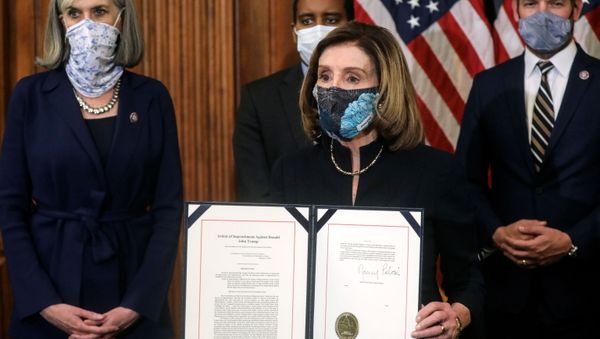 U.S. House Speaker Nancy Pelosi (D-CA) shows the article of impeachment against U.S. President Donald Trump after signing it in an engrossment ceremony, at the U.S. Capitol in Washington January 13, 2021 - Sputnik International