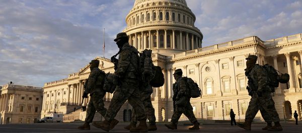 National Guard members walk in front of the U.S. Capitol after the House voted to impeach U.S. President Donald Trump in Washington, U.S., January 14, 2021 - Sputnik International