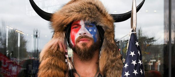 Jacob Anthony Chansley, also known as Jake Angeli, of Arizona, poses with his face painted in the colors of the US flag as supporters of US President Donald Trump gather in Washington, US, 6 January 2021 Jacob Anthony Chansley, also known as Jake Angeli, of Arizona, poses with his face painted in the colors of the US flag as supporters of US President Donald Trump gather in Washington, US, 6 January 2021 - Sputnik International