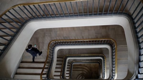 An official walks down the stairs prior to the visit of French President Emmanuel Macron at the Crisis and Support Center in the French Foreign Affairs ministry to give support and repatriation to French citizens abroad at Quai D'Orsay in Paris, Friday, April 3, 2020. Macron paid tribute to those who helped more than 130,000 French citizens to return to France since mid-March as countries across the world were closing their borders amid the coronavirus crisis. The new coronavirus causes mild or moderate symptoms for most people, but for some, especially older adults and people with existing health problems, it can cause more severe illness or death. - Sputnik International