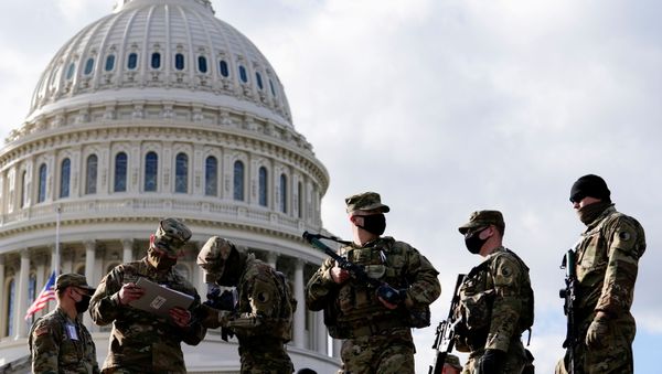 National Guard troops receive guns and ammunition outside the U.S. Capitol building as supporters of U.S. President Donald Trump are expected to protest against the election of President-elect Joe Biden, in Washington DC, U.S. January 17, 2021 - Sputnik International