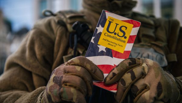 WASHINGTON, DC - JANUARY: 17 National Guard Master Sergeant George Roachs holds up a pamphlet of the U.S. Constitution on January 17, 2021 in Washington, DC. WASHINGTON, DC - JANUARY: 17 National Guard Master Sergeant George Roachs holds up a pamphlet of the U.S. Constitution on January 17, 2021 in Washington, DC. - Sputnik International