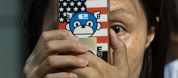 A woman takes a photo with a phone that has a United States flag themed cover outside the United States Consulate in Chengdu in southwest China's Sichuan province on Sunday, July 26, 2020 A woman takes a photo with a phone that has a United States flag themed cover outside the United States Consulate in Chengdu in southwest China's Sichuan province on Sunday, July 26, 2020 - Sputnik International