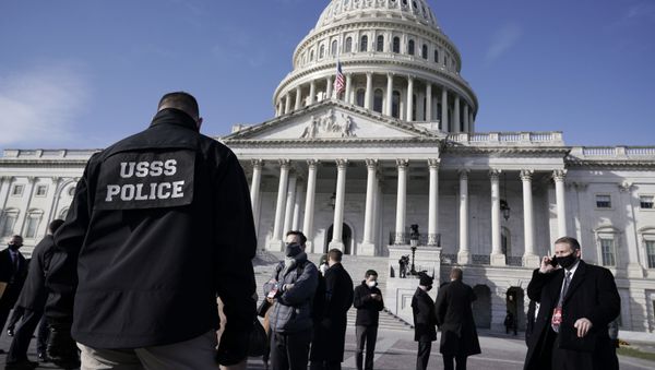 High level security officials make a survey of the East Front of the Capitol after an announcement of security problems during a rehearsal for the 59th Presidential Inauguration at the U.S. Capitol in Washington, Monday, Jan. 18, 2021. (AP Photo/J. Scott Applewhite) - Sputnik International