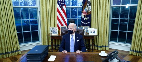 U.S. President Joe Biden signs executive orders in the Oval Office of the White House in Washington, after his inauguration as the 46th President of the United States, U.S., January 20, 2021. - Sputnik International