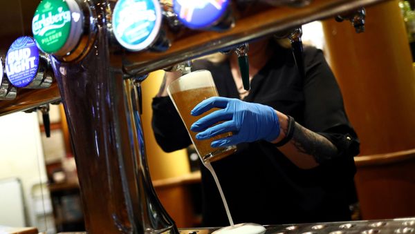FILE PHOTO: A worker serves a beer at The Holland Tringham Wetherspoons pub after it reopened following the outbreak of the coronavirus disease (COVID-19), in London, Britain July 4, 2020 - Sputnik International