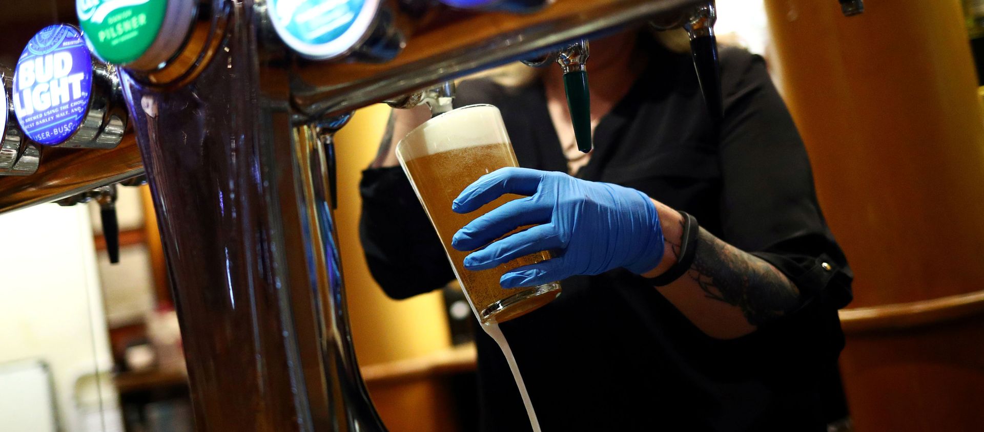 FILE PHOTO: A worker serves a beer at The Holland Tringham Wetherspoons pub after it reopened following the outbreak of the coronavirus disease (COVID-19), in London, Britain July 4, 2020 FILE PHOTO: A worker serves a beer at The Holland Tringham Wetherspoons pub after it reopened following the outbreak of the coronavirus disease (COVID-19), in London, Britain July 4, 2020 - Sputnik International, 1920, 22.01.2021