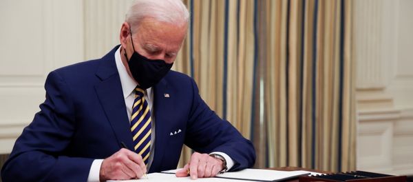 U.S. President Joe Biden and signs an executive order after speaking about his administration's plans to respond to the economic crisis during a coronavirus disease (COVID-19) response event in the State Dining Room at the White House in Washington, U.S., January 22, 2021. - Sputnik International