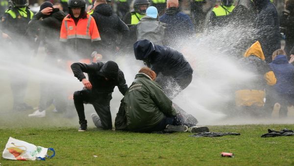 Police uses a water canon during a protest against restrictions put in place to curb the spread of the coronavirus disease (COVID-19), in Amsterdam, Netherlands January 24, 2021. - Sputnik International
