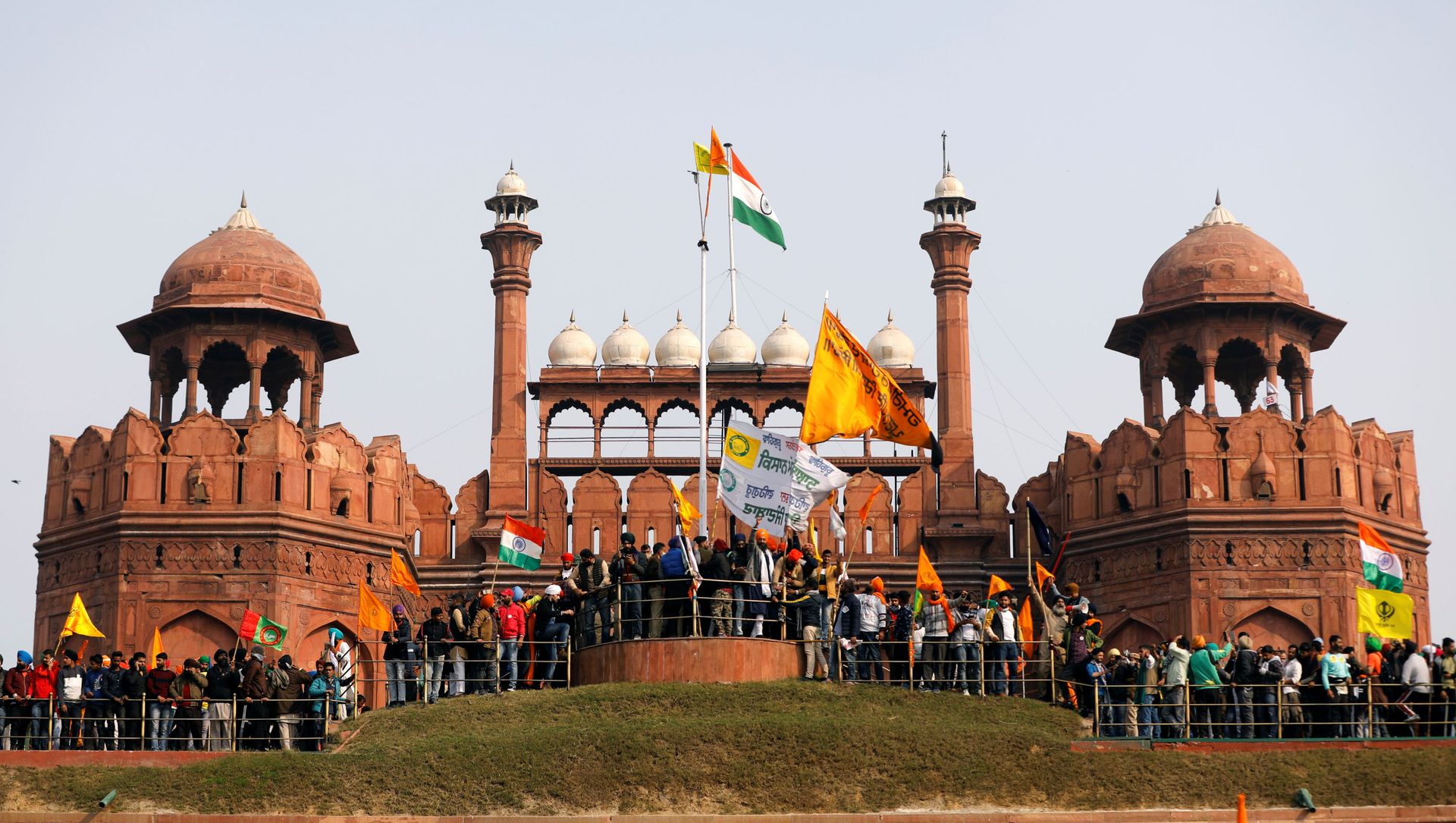 Farmers wave flags during a protest against farm laws introduced by the government, at the historic Red Fort in Delhi, India, January 26, 2021 Farmers wave flags during a protest against farm laws introduced by the government, at the historic Red Fort in Delhi, India, January 26, 2021 - Sputnik International, 1920, 03.02.2021