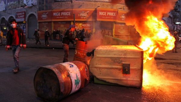 Garbage bins, set on fire by demonstrators, block a road during a protest against the lockdown and worsening economic conditions, amid the spread of the coronavirus disease (COVID-19), in Tripoli, Lebanon January 26, 2021. - Sputnik International