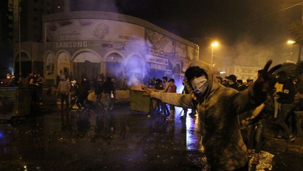 A demonstrator gestures during a protest against the lockdown and worsening economic conditions, amid the spread of the coronavirus disease (COVID-19), in Tripoli, Lebanon January 27, 2021. - Sputnik International