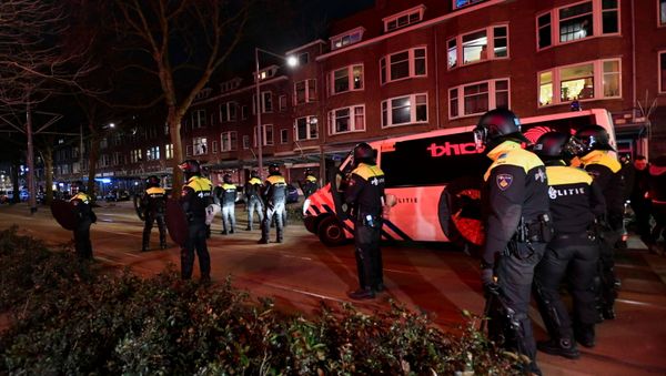 Police officers block a street during a demonstration against restrictions put in place to curb the spread of the coronavirus disease (COVID-19) in Rotterdam, Netherlands, January 26, 2021 Police officers block a street during a demonstration against restrictions put in place to curb the spread of the coronavirus disease (COVID-19) in Rotterdam, Netherlands, January 26, 2021 - Sputnik International