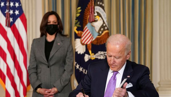 U.S. Vice President Kamala Harris watches as President Joe Biden signs executive orders on his racial equity agenda at the White House in Washington, U.S., January 26, 2021 - Sputnik International