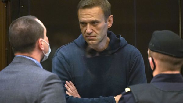 In this handout photo provided by Moscow City Court Russian opposition leader Alexei Navalny talks to one of his lawyers, left, while standing in the cage during a hearing to a motion from the Russian prison service to convert the suspended sentence of Navalny from the 2014 criminal conviction into a real prison term in the Moscow City Court in Moscow, Russia, Tuesday, Feb. 2, 2021. - Sputnik International