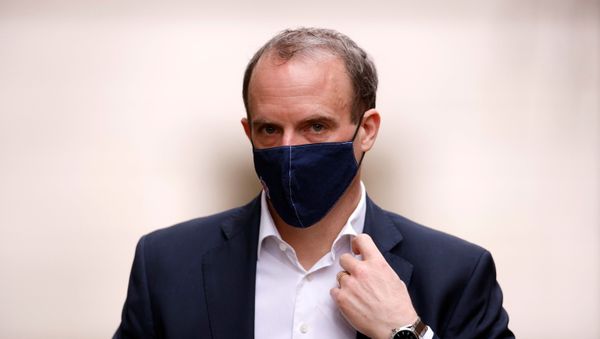 Britain's Foreign Affairs Secretary Dominic Raab walks outside Downing Street in London - Sputnik International