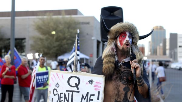 FILE - In this Nov. 5, 2020, file photo, Jacob Anthony Chansley, who also goes by the name Jake Angeli, a Qanon believer speaks to a crowd of President Donald Trump supporters outside of the Maricopa County Recorder's Office where votes in the general election are being counted, in Phoenix. In its annual report set to be released Monday, Feb. 1, 2021, the Southern Poverty Law Center said it identified 838 active hate groups operating across the U.S. in 2020. - Sputnik International