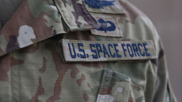 In this photo released by the U.S. Air Force, Capt. Ryan Vickers stands for a photo to display his new service tapes after taking his oath of office to transfer from the U.S. Air Force to the U.S. Space Force at Al-Udeid Air Base, Qatar, Tuesday, Sept. 1, 2020. - Sputnik International