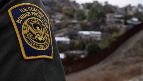 A US. border patrol agent looks out over Tijuana, Mexico from the US-Mexico border wall in San Diego, California, 2 February 2021. - Sputnik International
