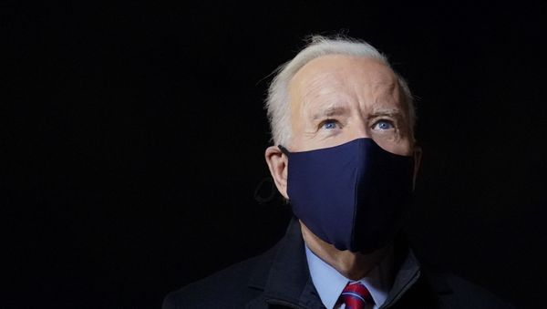 President Joe Biden speaks with reporters after stepping off Air Force One at New Castle Airport in New Castle, Del., Friday, Feb. 5, 2021. Biden is spending the weekend at his home in Delaware.  - Sputnik International