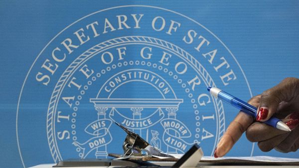 A voter fills out paperwork before casting her vote at the C.T. Martin Natatorium and Recreation Center in Atlanta on the first day of early voting for the senate runoff Monday, Dec. 14, 2020. Early in-person voting began Monday in Georgia for the state's twin U.S. Senate runoffs. The early voting period runs as late as Dec. 31 in some counties. It could determine the outcome of the races between Republican U.S. Sens. David Perdue and Kelly Loeffler and Democratic challengers Jon Ossoff and Raphael Warnock. - Sputnik International