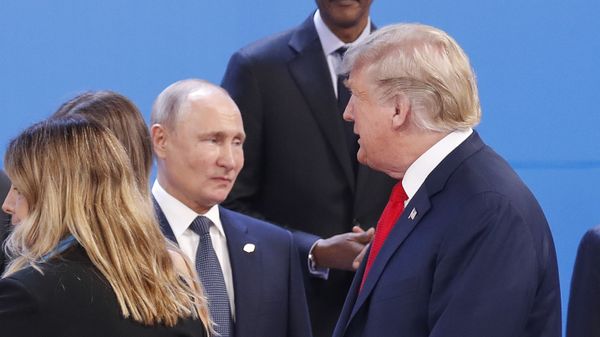 President Donald Trump, right, walk past Russia's President Vladimir Putin, left, as they gather for the group photo at the start of the G20 summit in Buenos Aires, Argentina, Friday, Nov. 30, 2018 - Sputnik International