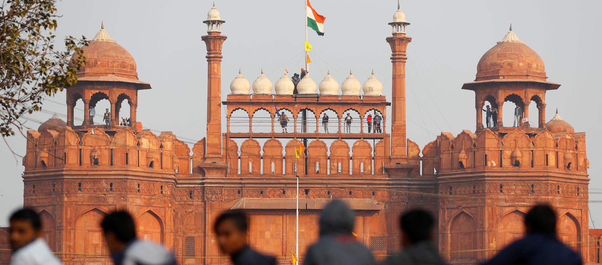 A farmer holds a flag on top of the historic Red Fort, during a protest against farm laws introduced by the government, in Delhi, India. - Sputnik International, 1920, 11.02.2021