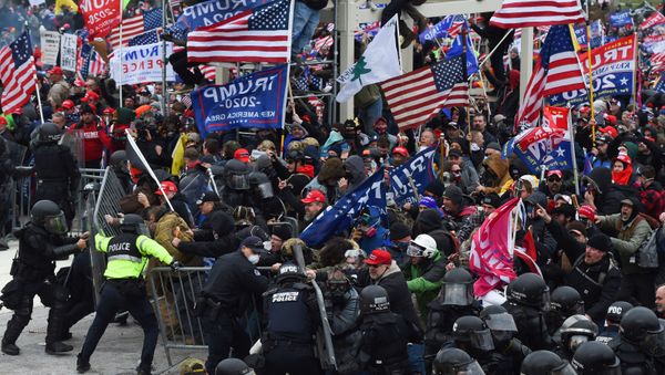 In this file photo taken on January 06, 2021 Trump supporters clash with police and security forces as they push barricades to storm the US Capitol in Washington D.C. - Impeachment prosecutors aired terrifying, never-before-seen footage of senior US politicians fleeing for their lives during the January assault on Congress by Donald Trump supporters on day two of the former president's Senate trial. With painstaking, graphic presentations, Democratic impeachment managers walked senators through hours of video, some of which came from security cameras and police bodycams and was being aired for the first time. - Sputnik International