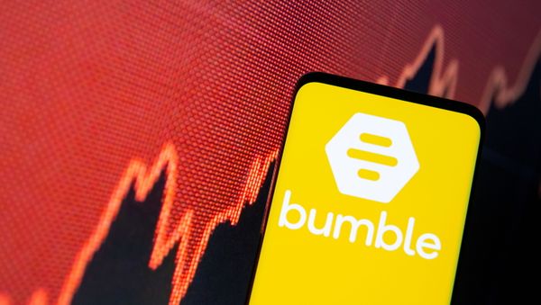 The Bumble logo is seen on a smartphone in front of a stock graph in this illustration taken February 11, 2021 - Sputnik International