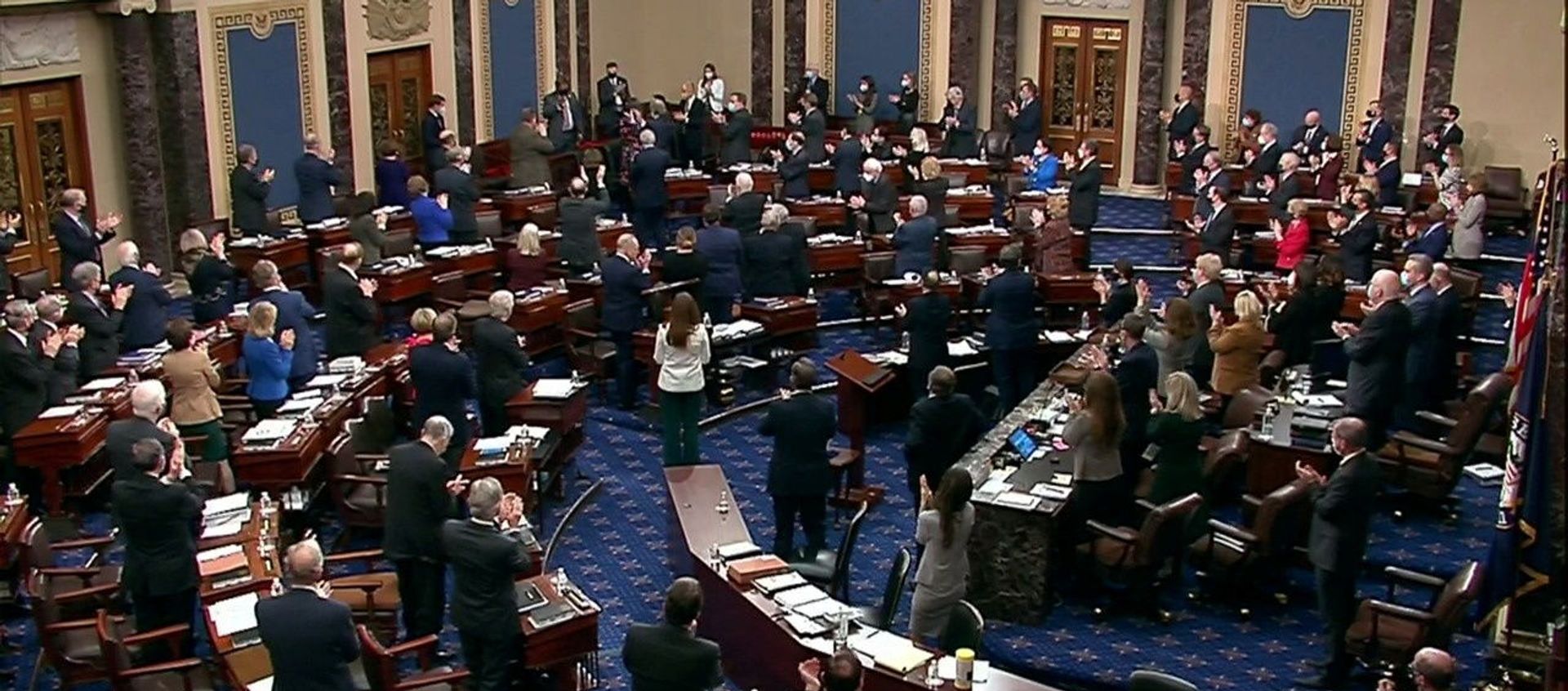 U.S. Capitol Police Officer Eugene Goodman (top) acknowledges a standing ovation from U.S. Senators, the House of Representatives impeachment managers and former President Donald Trump’s attorneys just before the Senate awards Goodman a Congressional Gold Medal during the fourth day of the impeachment trial of the former president on charges of inciting the deadly attack on the U.S. Capitol, on Capitol Hill in Washington, U.S., February 12, 2021. U.S. Capitol Police Officer Eugene Goodman (top) acknowledges a standing ovation from U.S. Senators, the House of Representatives impeachment managers and former President Donald Trump’s attorneys just before the Senate awards Goodman a Congressional Gold Medal during the fourth day of the impeachment trial of the former president on charges of inciting the deadly attack on the U.S. Capitol, on Capitol Hill in Washington, U.S., February 12, 2021. - Sputnik International, 1920, 13.02.2021
