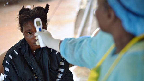  this file photo taken on August 16, 2014 shows a girl suspected of being infected with the Ebola virus having her temperature checked at the government hospital in Kenema. - Four people have died of Ebola in Guinea, the first resurgence of the haemorrhagic fever in the West African nation since a 2013-2016 epidemic left thousands dead, Health Minister Remy Lamah said on February 13, 2021.  - Sputnik International