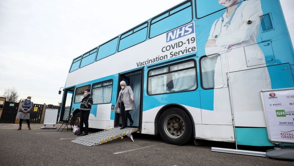 A person gets off a mobile vaccination centre for the coronavirus disease (COVID-19) after receiving the vaccine, in Thamesmead, London, Britain, February 14, 2021. - Sputnik International