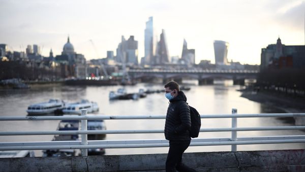 A man wearing a protective face mask walks across Waterloo Bridge, amid the coronavirus disease (COVID-19) outbreak in London, Britain, January 29, 2021. - Sputnik International