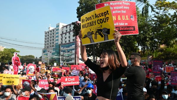Demonstrators hold placards during a protest against the military coup in Yangon, Myanmar, 15 February 2021 - Sputnik International