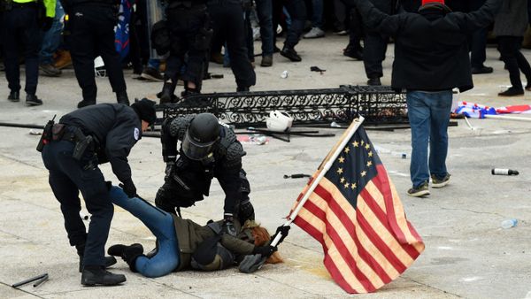In this file photo taken on January 6, 2021, police detain a person as supporters of US President Donald Trump riot outside the US Capitol in Washington, DC. - - Sputnik International