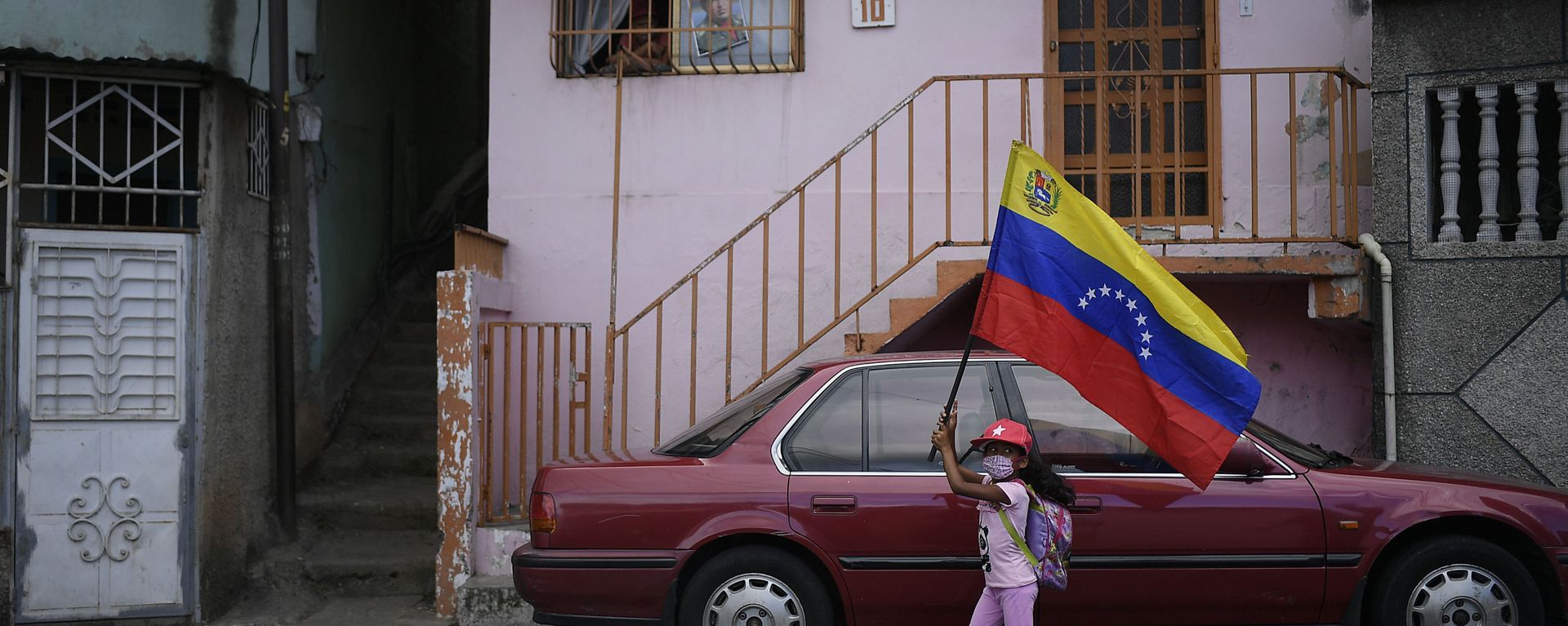 A girl flies a Venezuelan flag during the anniversary of his 1992 failed coup attempt by the late President Hugo Chavez at the 23 de Enero neighborhood of Caracas, Venezuela, Thursday, Feb. 4, 2021. A girl flies a Venezuelan flag during the anniversary of his 1992 failed coup attempt by the late President Hugo Chavez at the 23 de Enero neighborhood of Caracas, Venezuela, Thursday, Feb. 4, 2021. - Sputnik International, 1920, 16.02.2021