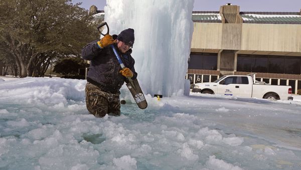 City of Richardson worker Kaleb Love breaks ice on a frozen fountain Tuesday, Feb. 16, 2021, in Richardson, Texas - Sputnik International