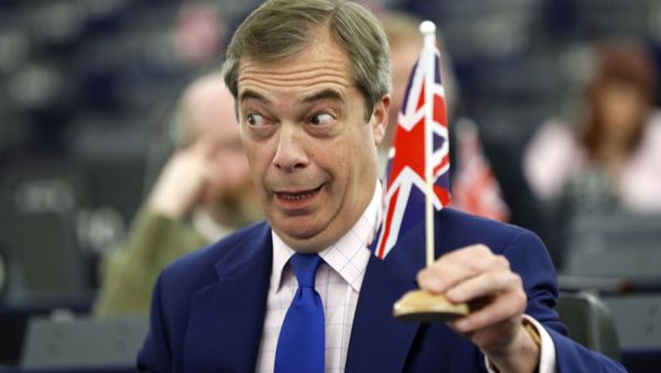 In this Wednesday, March 13, 2019 file photo, former U.K. Independence Party (UKIP) leader and member of the European Parliament Nigel Farage holds a U.K. flag during a plenary session at the European Parliament in Strasbourg, eastern France.  - Sputnik International