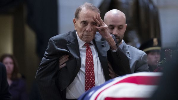 Former US Senator Bob Dole salutes before the flag-draped coffin of former US President George H. W. Bush at the US Capitol rotunda December 4, 2018 in Washington, DC.  - Sputnik International