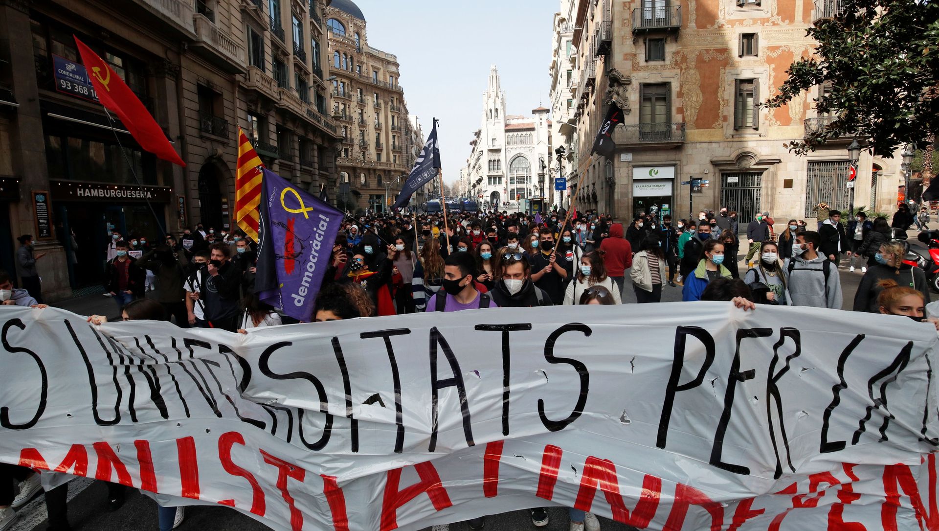 Demonstrators hold a banner during a protest in support of Catalan rapper Pablo Hasel, after he was given a jail sentence on charges of glorifying terrorism and insulting royalty in his songs, in Barcelona, Spain, February 19, 2021 Demonstrators hold a banner during a protest in support of Catalan rapper Pablo Hasel, after he was given a jail sentence on charges of glorifying terrorism and insulting royalty in his songs, in Barcelona, Spain, February 19, 2021 - Sputnik International, 1920, 19.02.2021
