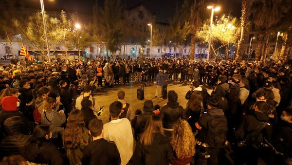 People sing during a protest in support of Catalan rapper Pablo Hasel, after he was given a jail sentence on charges of glorifying terrorism and insulting royalty in his songs, in Barcelona, Spain, February 19, 2021. - Sputnik International
