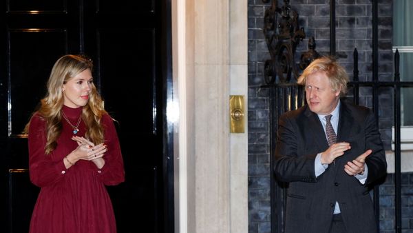 Britain's Prime Minister Boris Johnson and partner Carrie Symonds applaud outside 10 Downing Street during a national clap for late Captain Sir Tom Moore and NHS workers, amidst the coronavirus disease (COVID-19) outbreak, in London, Britain, February 3, 2021.  - Sputnik International